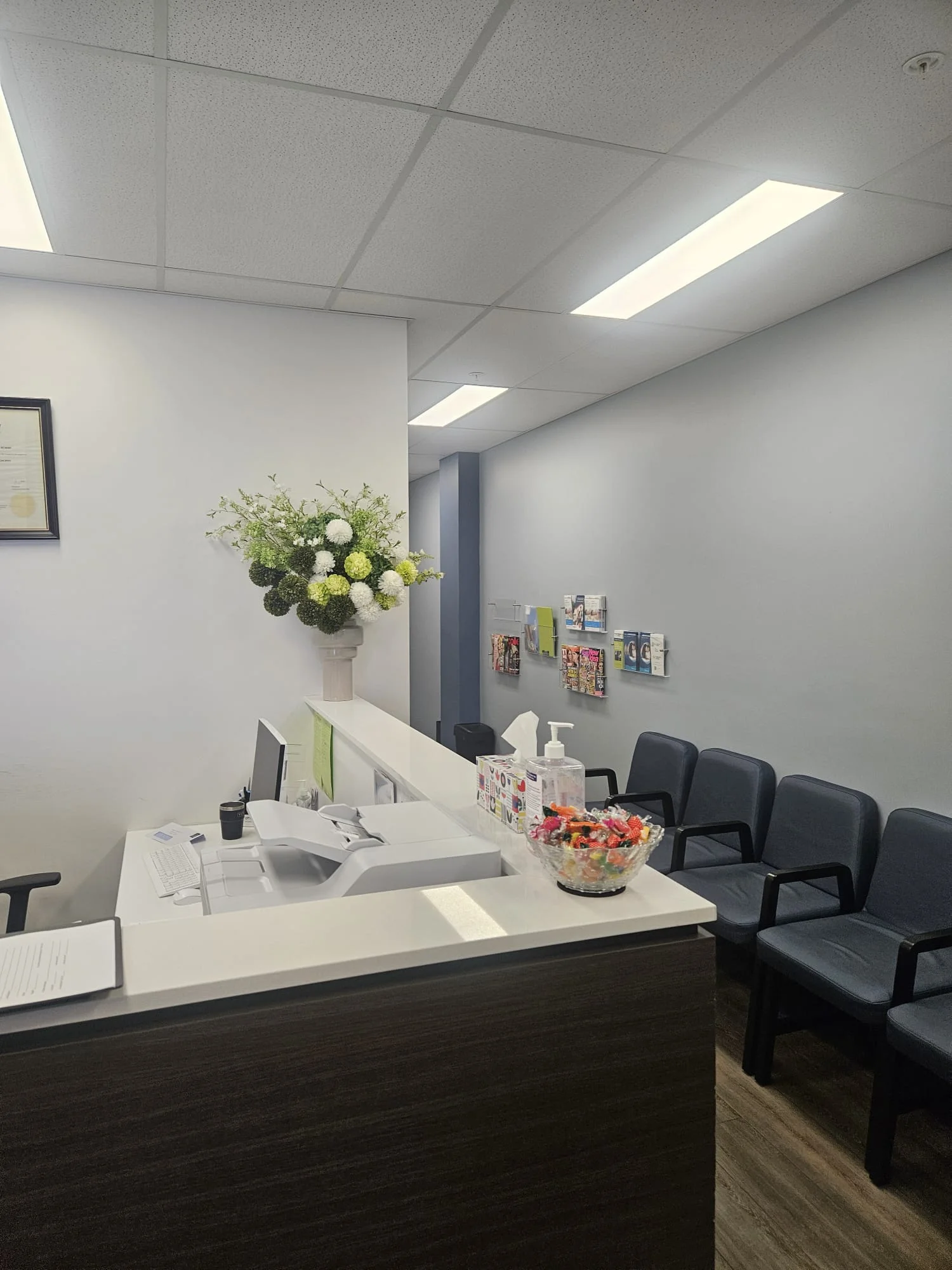 White and green floral arrangement on a corporate reception desk